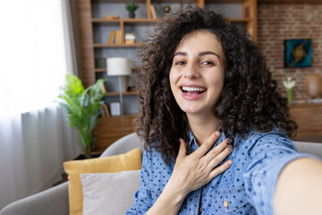 Happy woman making a video call from home office