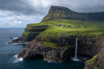 A stunning waterfall tumbles over rugged cliffs into the deep blue sea, surrounded by lush green hills in the Faroe Islands. The sky is partly cloudy, creating a serene atmosphere