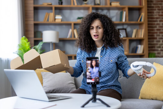 Frustrated influencer complaining about headphones during live stream at home
