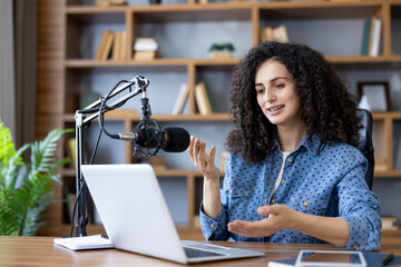 Content creator recording podcast using professional microphone and laptop