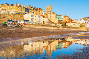 Sea reflections of buildings in the North Norfolk town of Cromer including the 19th Century Parish...