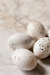 Celebration of world egg day with speckled eggs on marble surface for culinary inspiration. Vertical banner. Copy space. World Farm Animals Day. World Bird Day. Healthy farm food