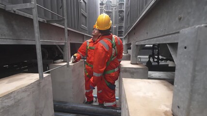 Workers conduct maintenance in an industrial facility during the daytime