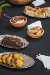 Homemade cornmeal cake squares topped with rich chocolate frosting served on a tray