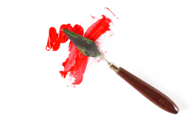 Metal spatula and red brush strokes acrylic paint isolated on white, top view