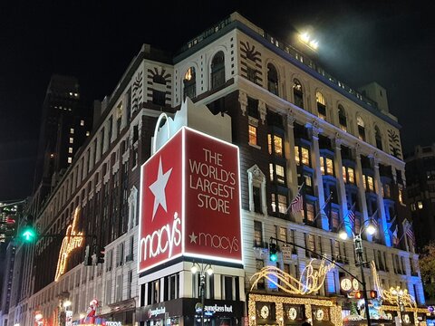 The famous landmark department store Macy's in Manhattan, New York, is decorated with festive Christmas lights to celebrate the holiday season on a winter night.