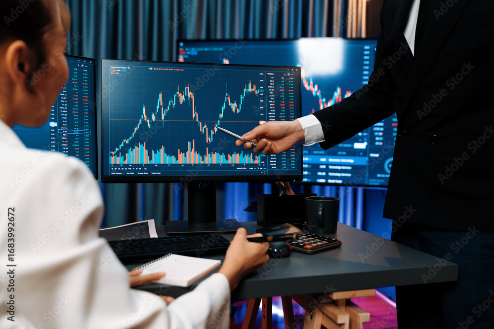 Poster smiling asian business traders pointing to dynamic stock exchange data screen profit value online we