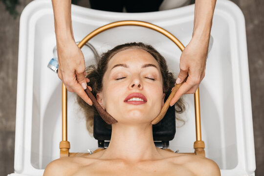 Woman receiving relaxing facial massage with natural tools in a serene spa environment, showcasing the soothing benefits of skincare and wellness treatments for rejuvenation and relaxation - Powered by Adobe