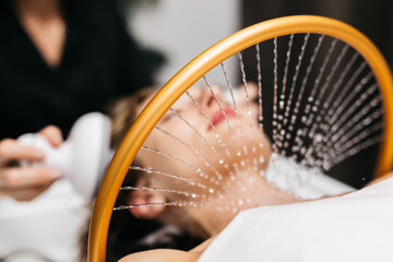 Woman receiving hydromassage therapy in a serene spa environment, with soothing water jets creating...