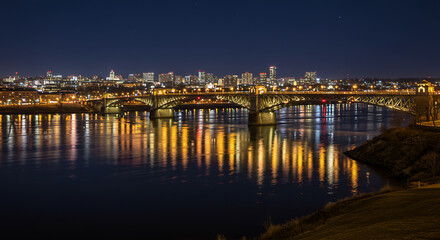 A night cityscape with the bright city lights reflecting beautifully on the water. 