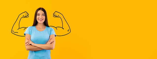 A woman stands confidently with her arms crossed, showcasing a vibrant smile. Behind her, a mural...