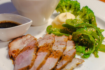 Dinner plate with pork sauté and assorted vegetables
