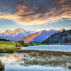 Fabulous autumn view of Haidersee (Lago della Muta) lake with Ortler peak on background.