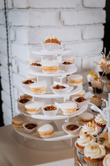 Luxury candy bar with cupcakes, macarons, and desserts on elegant golden trays