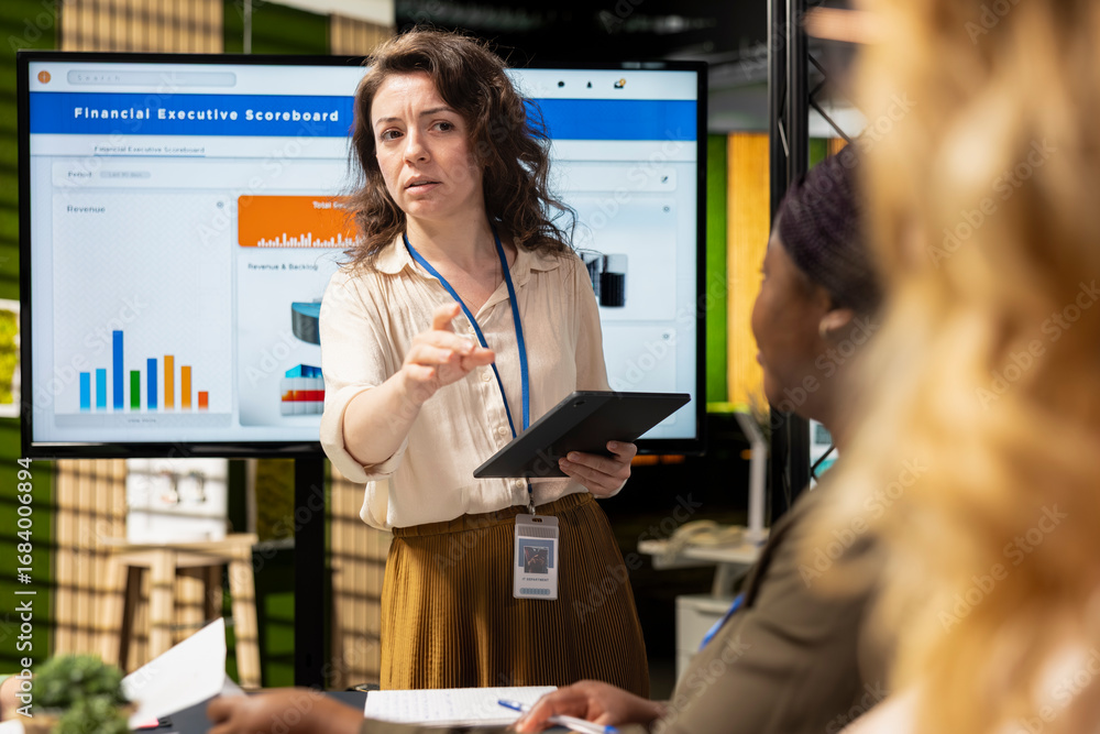 Poster diverse businesswomen working side by side to review data on tv monitor in the boardroom, collaborat