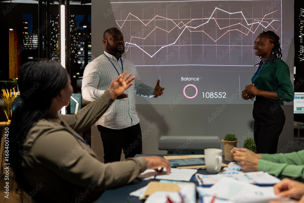 Poster team of company analysts reviews feedback on sales and orders to work on future improvements, develo