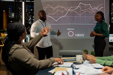 Team of company analysts reviews feedback on sales and orders to work on future improvements,...