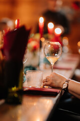 Elegant dinner party table setting with candles, wine and cozy atmosphere