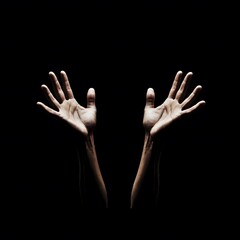 Fototapeta premium Dramatic Open Hands Reaching Upward Dark Background