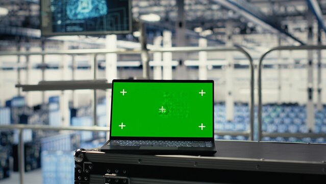 Green screen laptop in server hub with hardware supporting AI driven services. Mockup notebook in data center storing and processing vast datasets for artificial intelligence operations - Powered by Adobe