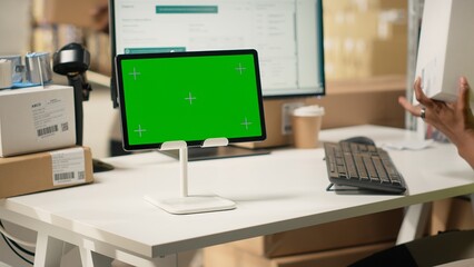 African american staff checking cardboard boxes with chroma key on computer, monitoring parcel...