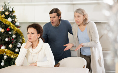 On Christmas Eve man and mature mother yell at adult sister. Family conflict between relatives...