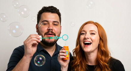 A Cheerful Couple Enjoys Blowing Bubbles Together Creating a Joyful Moment on an Isolated White Background