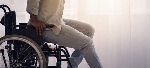 Obraz premium Healing, training and willpower, injury recovery. Concentrate tense mature african american man disabled stands up from wheelchair at large window background in living room interior, copy space