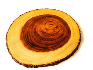 Luxurious wooden cutting board on white background. Round shape kitchen tool with yellow and rich brown color tone. Woodcraft product with high quality finish.