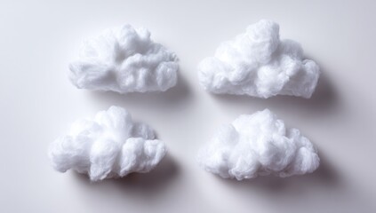 Four fluffy white cloud shapes arranged in a grid pattern on a plain white background
