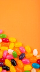 Obraz premium Colorful jelly beans on orange background (1)