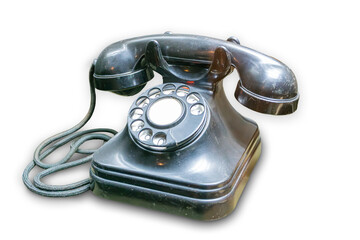 An old-fashioned rotary dial telephone with a dark, glossy finish and hanging receiver, set against...