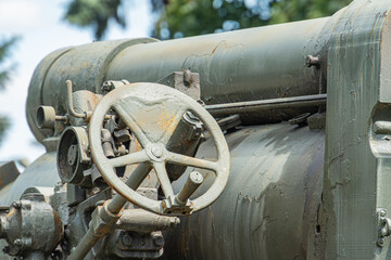 Oxidized vintage artillery piece, possibly a historical firearm or cannon, with intricate...