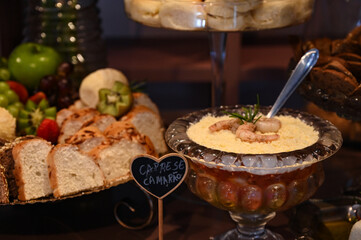 delicious buffet with shrimp casserole and artisanal breads, assorted party foods on a festive...