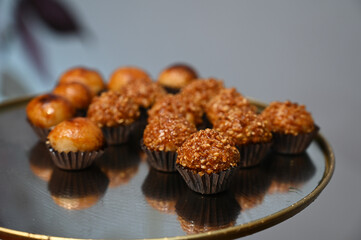 delicious brazilian brigadeiros on a golden plate, gourmet party sweets and confectionery, variety...