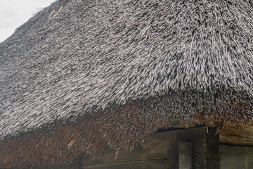 Overhead view of an aged, weathered thatched roof building in an ancient Central European village...