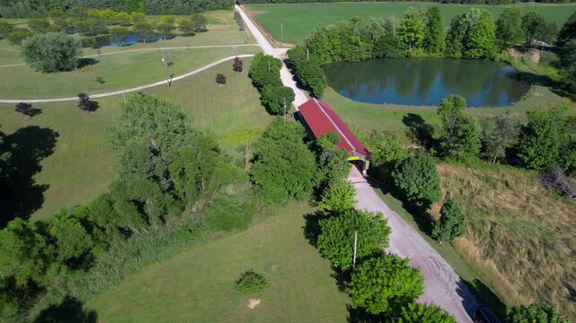 Aerial front view of historic Caine road covered bridge in Ashtabula County Ohio, USA