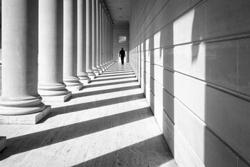 Columns and Shadows with Man Walking