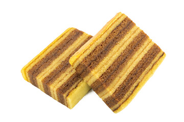 View of two slices of traditional Indonesian lapis legit cake. The slices are stacked diagonally, showcasing the intricate alternating layers of golden-yellow and chocolate-brown.
