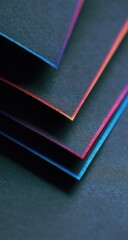Fototapeta premium Close-up of layered dark papers, edges showing vibrant hues