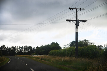 Power post and power lines under the stormy sky. Taranaki.