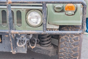 Military camouflage utility vehicle, off-road tires, spare tire, overcast sky, soft shadows, glossy...