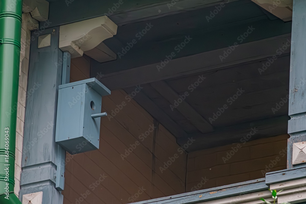 Aufkleber close-up view of two green-blue overlapping rectangular elements on architectural structure, uneven 