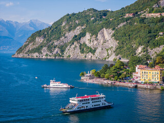 Como lake ferry boat, Lombardy, Italy. Aerial panoramic drone view of ship sailing between...