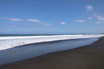 black sand beach and sea