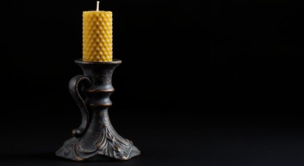 Honeycomb candle in dark candle holder