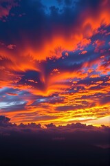 Fototapeta premium Vibrant sky transitioning from deep blue to fiery orange hues at sunset, panoramic, air