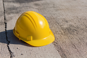 Construction Yellow Safety Helmet on Concrete Floor