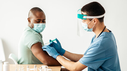 Covid-19 outbreak, vaccine to protect health and to get certificate. Millennial doctor in...
