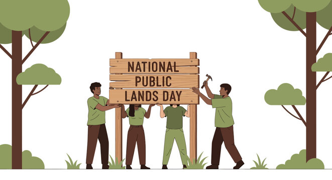 Diverse group erecting a National Public Lands Day sign in a forest.